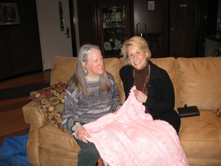 Donna presents a hand-made pink afghan to Scranton-area TV news anchor Lyndall Stout in honor of her work promoting breast self-exam: photo by Rich Hill