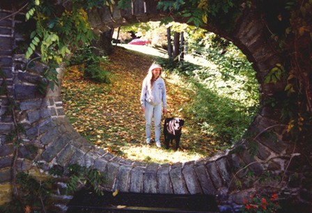 This picture of a blind girl & her black guide dog in the oval opening in a stone wall at Grey Towers National Historic Site could be Abigail & Curly Connor from The Heart of Applebutter Hill at Bar Gundoom Castle: photo by Rich Hill