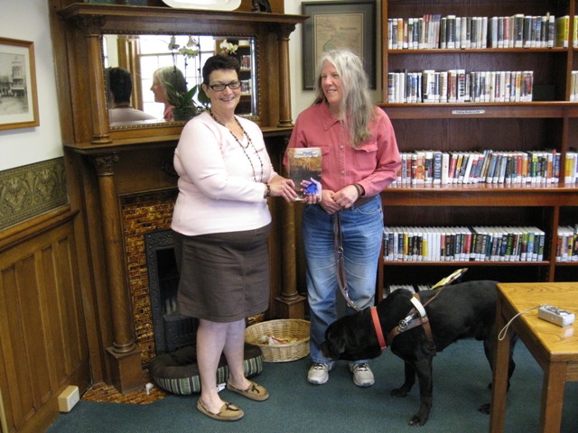 Donna W. Hill donates educator-recommended novel The Heart of Applebutter Hill to Wyalusing Library Dir. Cathy Brady: photo by Rich Hill