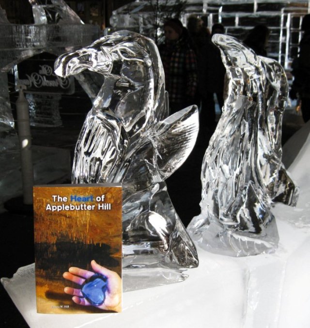 Ice penguins investigate a print copy of Donna W. Hill's The Heart of Applebutter Hill: photo by Rich Hill. 