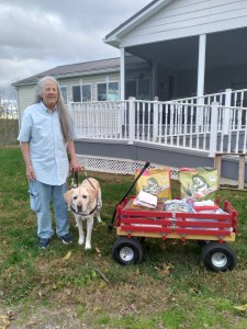 Donna Hill & guide dog Mo take wagon full of donations for Meshoppen Cat Rescue to rural bus for nondrivers.